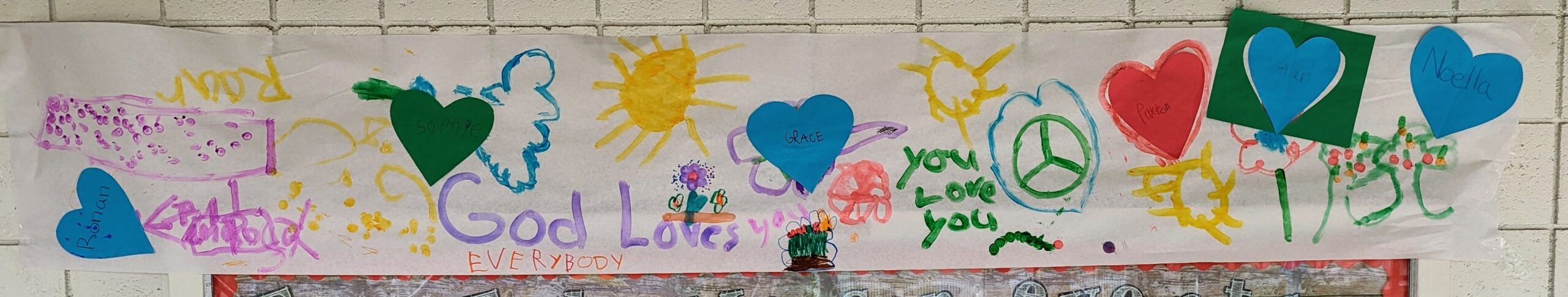 "God Loves Everybody" banner created by the Children Sunday School.